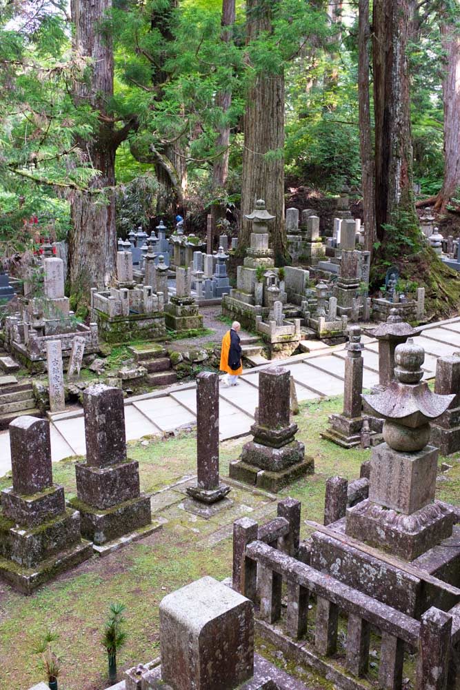 A monk walks through Okunoin cemetery in Koyasan Japan